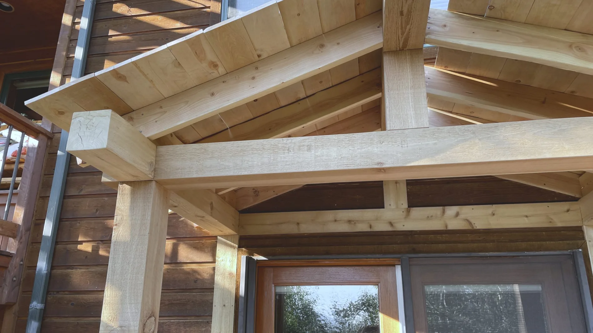 Timber entry portico framed in, rafters and ridge exposed before the roof deck went on