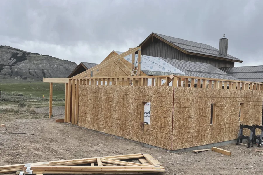 Wall sheathing on, gable framing started