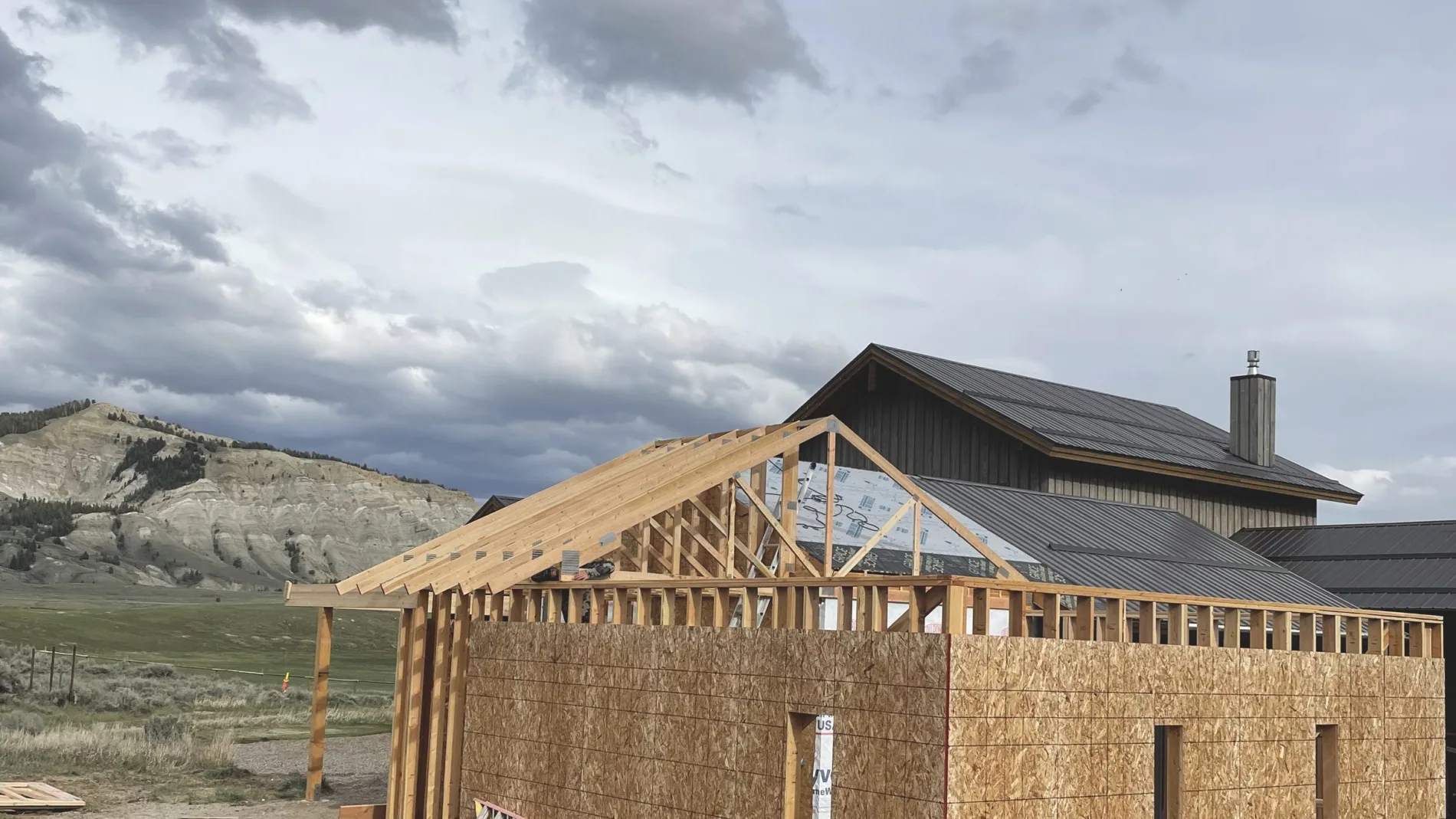 Roof trusses set and braced over sheathed exterior walls