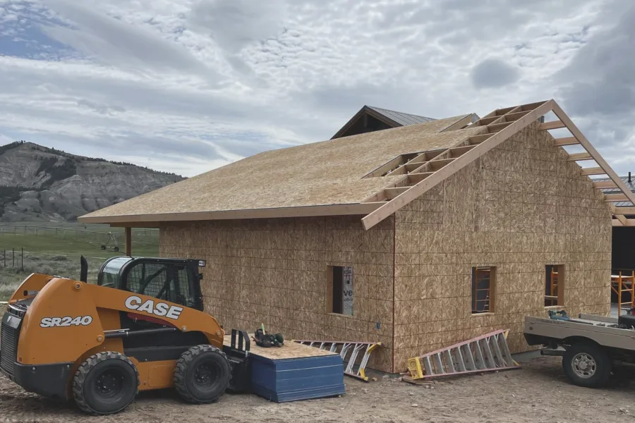 Roof decked, skid steer staged for the next lift